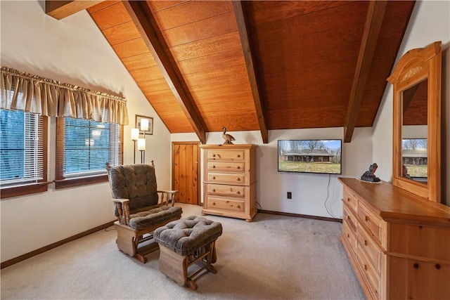 sitting room featuring lofted ceiling with beams, wooden ceiling, baseboards, and light colored carpet