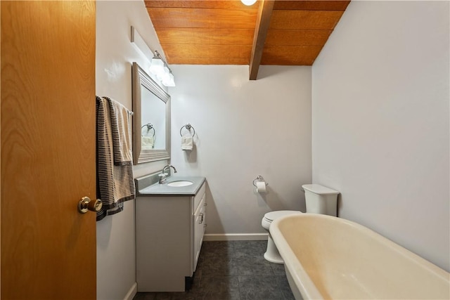 bathroom with lofted ceiling with beams, vanity, wood ceiling, a freestanding bath, and baseboards