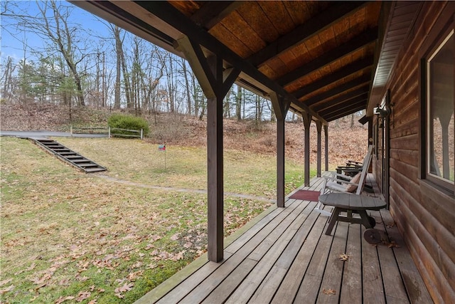 wooden terrace with a lawn