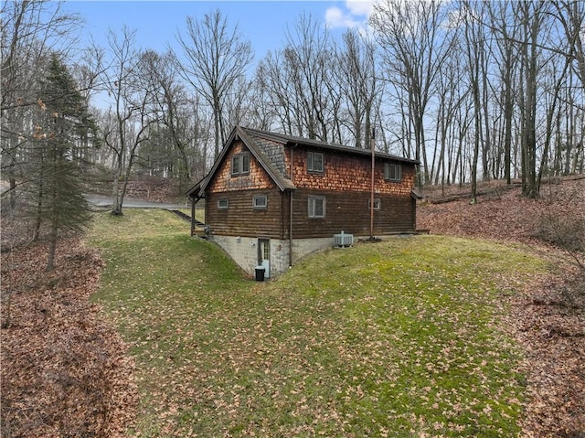 view of side of home featuring a yard and cooling unit