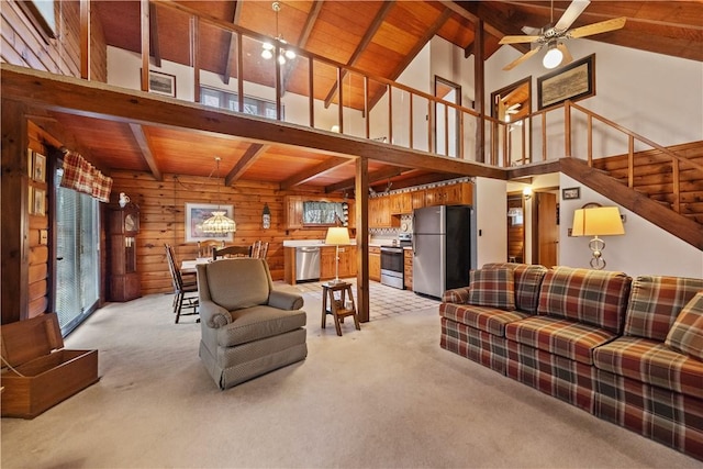 living area featuring ceiling fan, stairway, wood ceiling, and light colored carpet