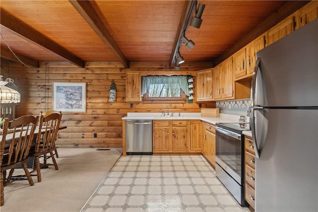 kitchen with wooden ceiling, wood walls, light countertops, appliances with stainless steel finishes, and light floors