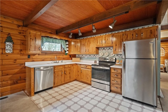 kitchen featuring wood ceiling, appliances with stainless steel finishes, light countertops, light floors, and a sink