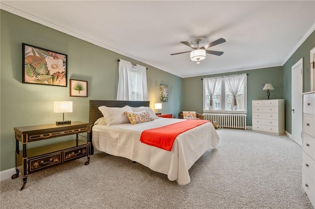 carpeted bedroom with ornamental molding, radiator, ceiling fan, and baseboards