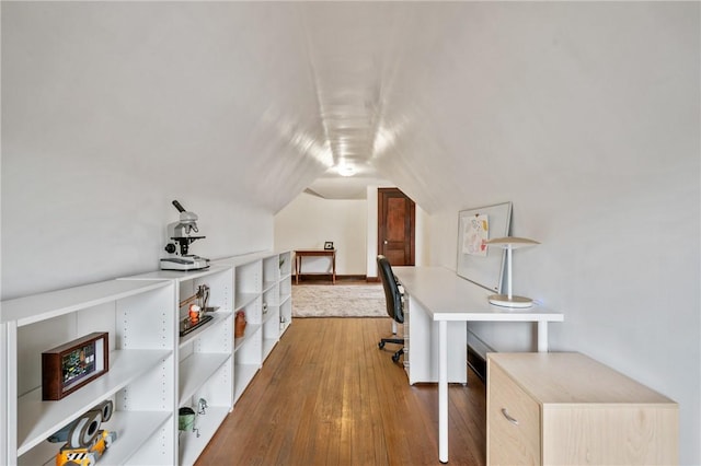 office space featuring vaulted ceiling and wood finished floors