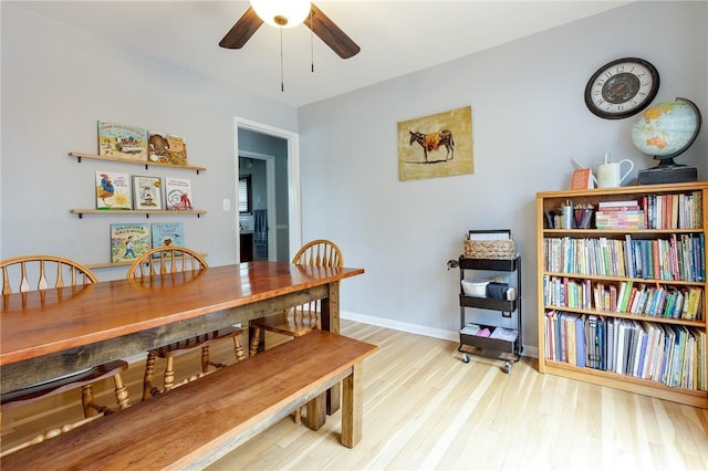 dining room with light wood-style floors, ceiling fan, and baseboards