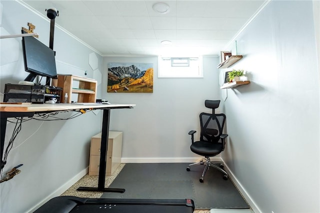 workout area with baseboards and crown molding