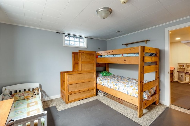 bedroom featuring crown molding and baseboards