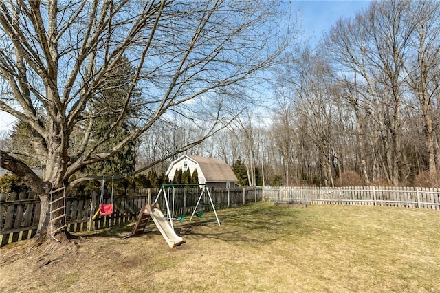 view of yard with a playground and a fenced backyard