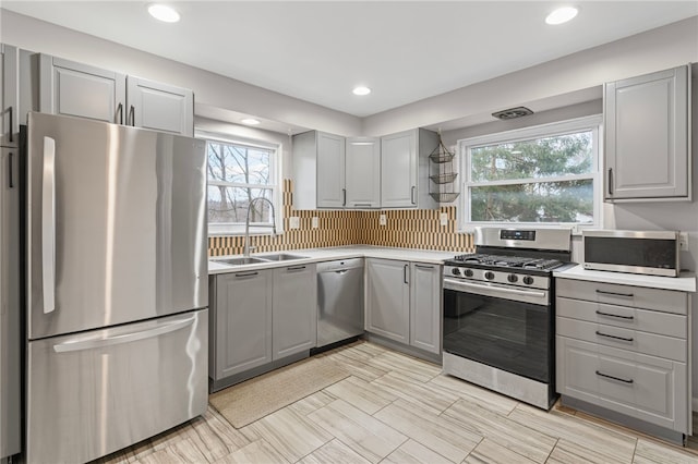 kitchen with appliances with stainless steel finishes and gray cabinets