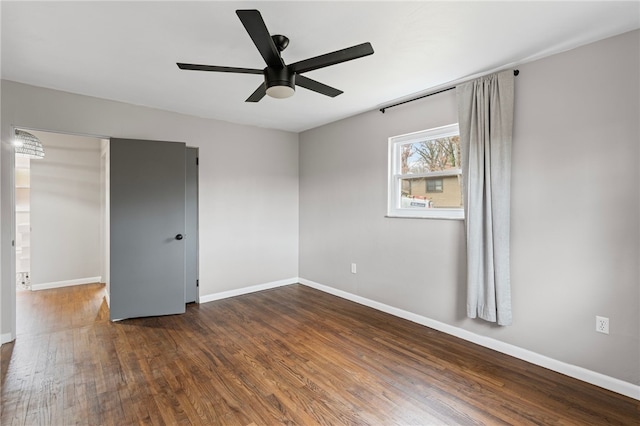 unfurnished room with ceiling fan, baseboards, and wood finished floors