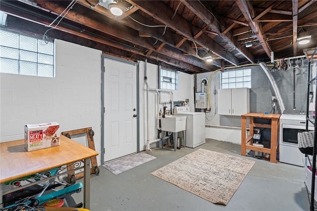 basement with a sink and washer and dryer