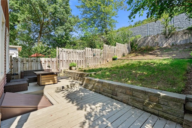 wooden deck featuring a fenced backyard