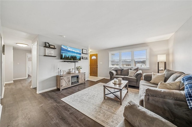 living room featuring baseboards, dark wood-type flooring, and indoor wet bar