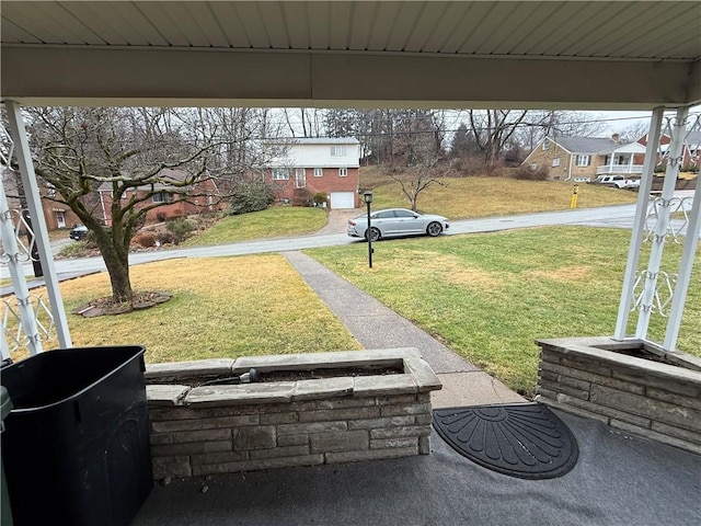 view of yard featuring a residential view and a carport