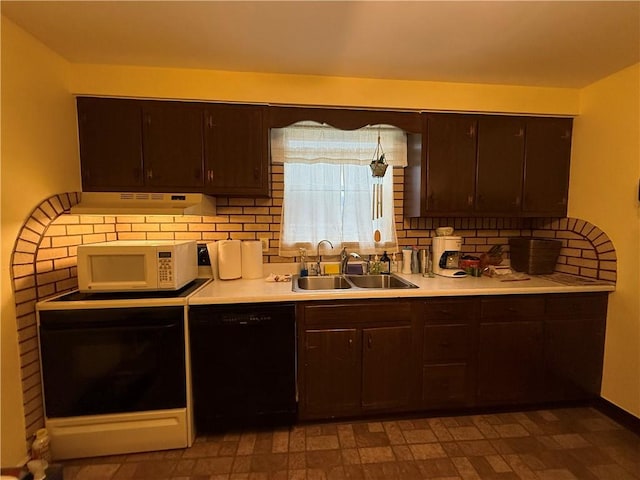 kitchen with dishwasher, white microwave, light countertops, dark brown cabinets, and a sink