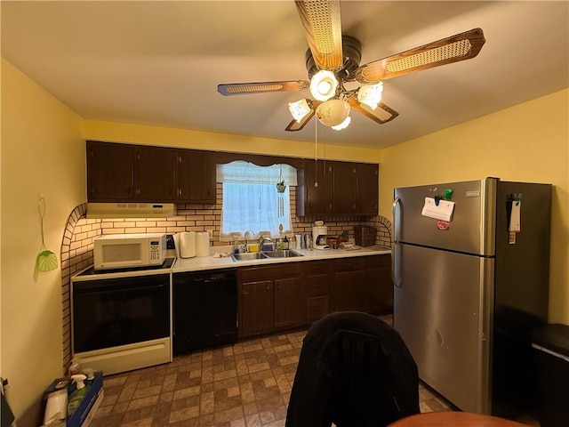 kitchen with black dishwasher, white microwave, freestanding refrigerator, a sink, and dark brown cabinets