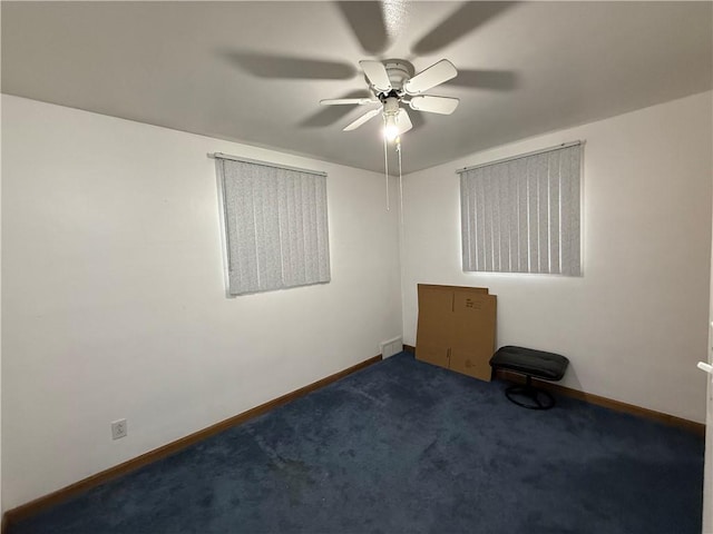 spare room featuring carpet floors, baseboards, and a ceiling fan