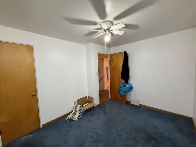 unfurnished bedroom with a ceiling fan, carpet, and baseboards