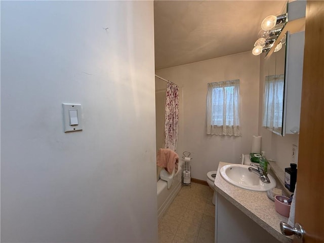 bathroom with toilet, tile patterned floors, vanity, and baseboards