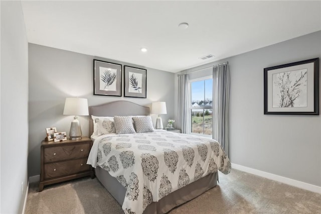 carpeted bedroom featuring visible vents and baseboards