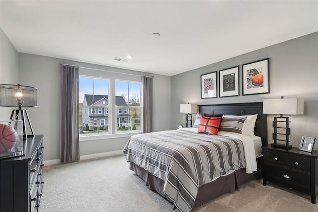 bedroom featuring carpet flooring, visible vents, and baseboards