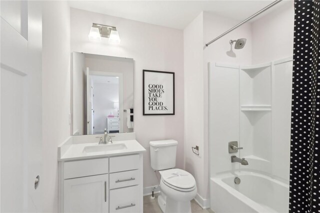 full bath featuring toilet,  shower combination, vanity, and baseboards