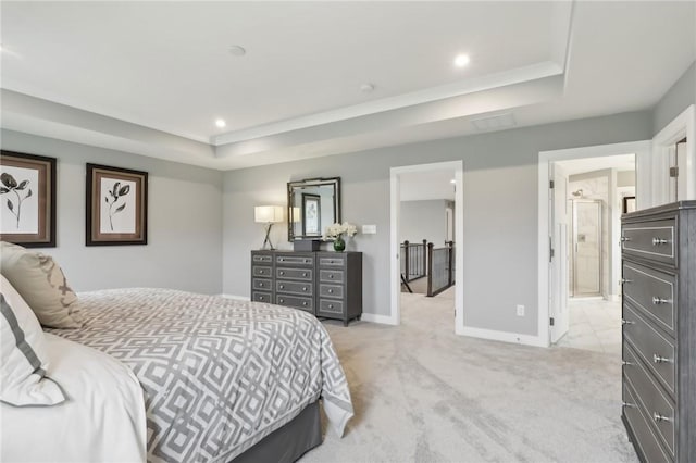 bedroom with a tray ceiling, light carpet, baseboards, and recessed lighting