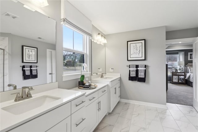 bathroom featuring ensuite bathroom, vanity, visible vents, baseboards, and marble finish floor