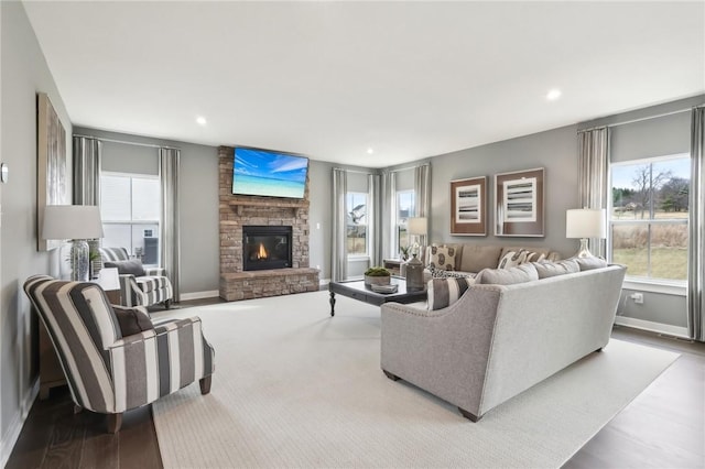 living area with recessed lighting, a fireplace, and baseboards