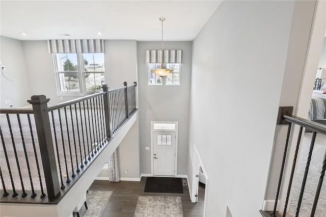 stairs with recessed lighting, baseboards, and wood finished floors