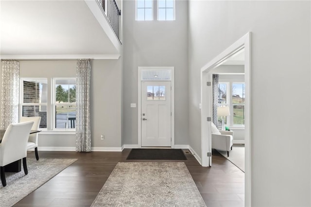 entrance foyer featuring dark wood-style floors and a wealth of natural light