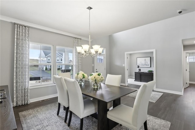 dining room with an inviting chandelier, visible vents, baseboards, and dark wood finished floors