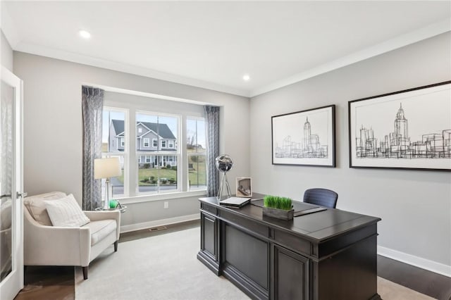 home office featuring light wood finished floors, baseboards, and crown molding