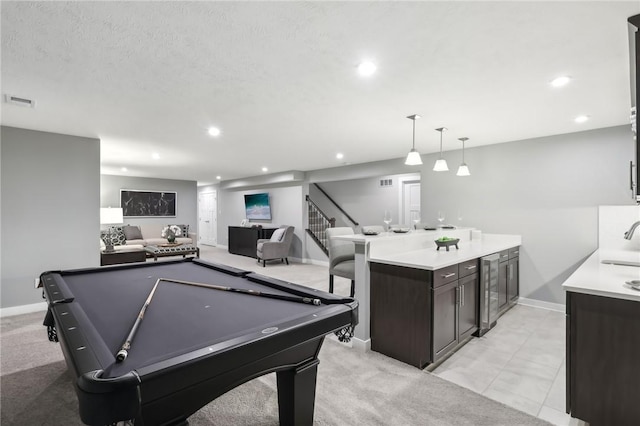 recreation room featuring recessed lighting, a sink, and baseboards