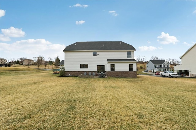 rear view of property with a lawn