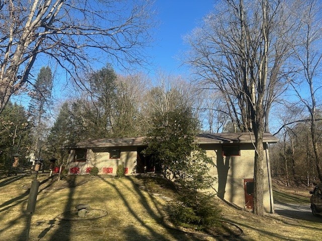 exterior space featuring a front yard and brick siding