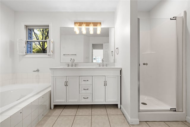 full bathroom with double vanity, a shower stall, a sink, and tile patterned floors