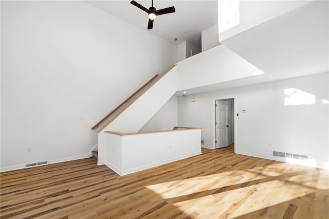 additional living space featuring stairs, visible vents, and wood finished floors