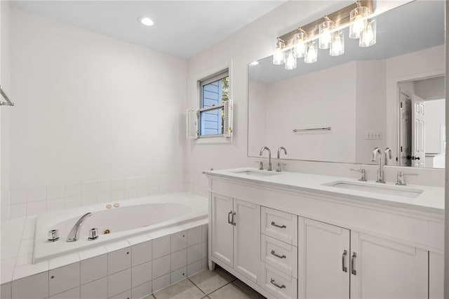 bathroom with tile patterned flooring, double vanity, a sink, and a bath