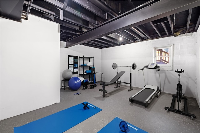 workout area with concrete block wall