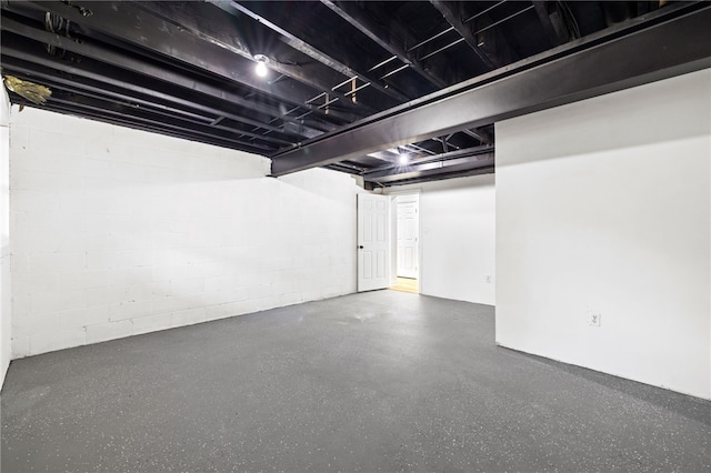 unfinished basement with concrete block wall