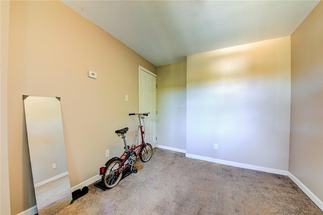 exercise room with carpet floors and baseboards