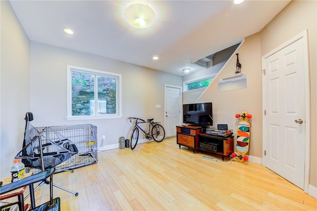 rec room featuring recessed lighting, baseboards, and light wood finished floors