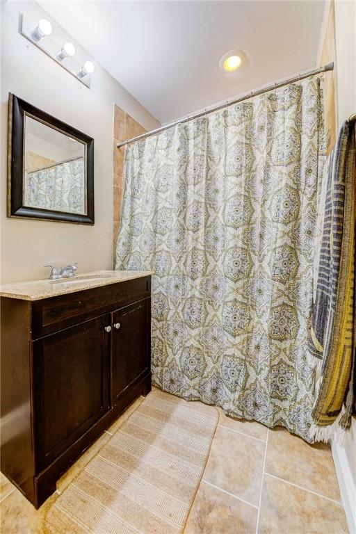 full bath featuring vanity and tile patterned floors