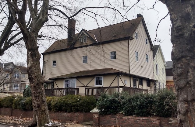 back of house featuring a chimney