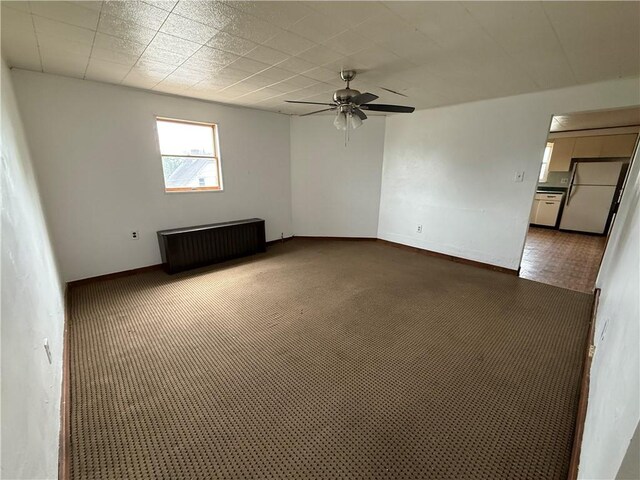 705 E 18th Ave, Munhall, PA 15120 - empty room featuring ceiling fan, radiator, and baseboards