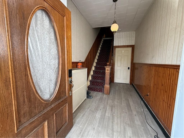 705 E 18th Ave, Munhall, PA 15120 - foyer entrance featuring wallpapered walls, stairs, light wood-style flooring, and wainscoting