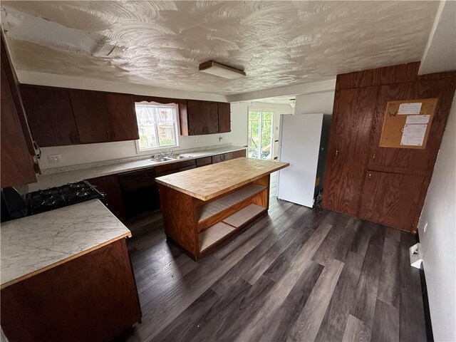 705 E 18th Ave, Munhall, PA 15120 - kitchen featuring freestanding refrigerator, plenty of natural light, dark wood-type flooring, and dark brown cabinetry