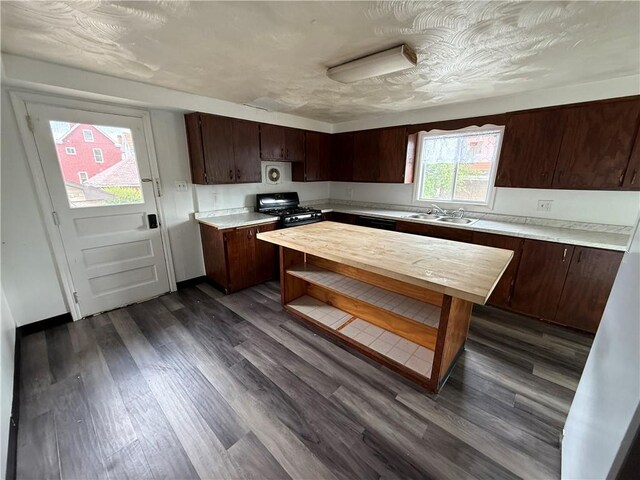 705 E 18th Ave, Munhall, PA 15120 - kitchen with black gas range oven, a sink, dark brown cabinets, dark wood-type flooring, and wooden counters